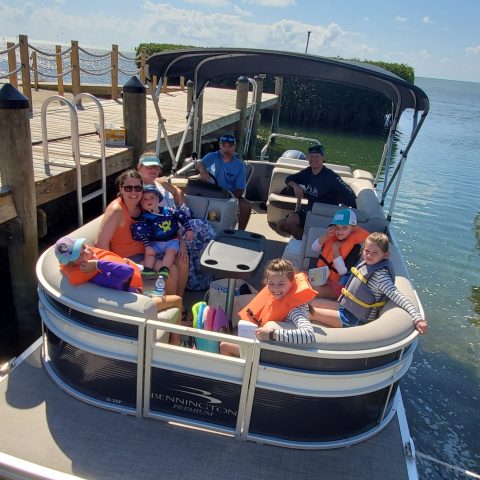 a group of people on a boat in the water